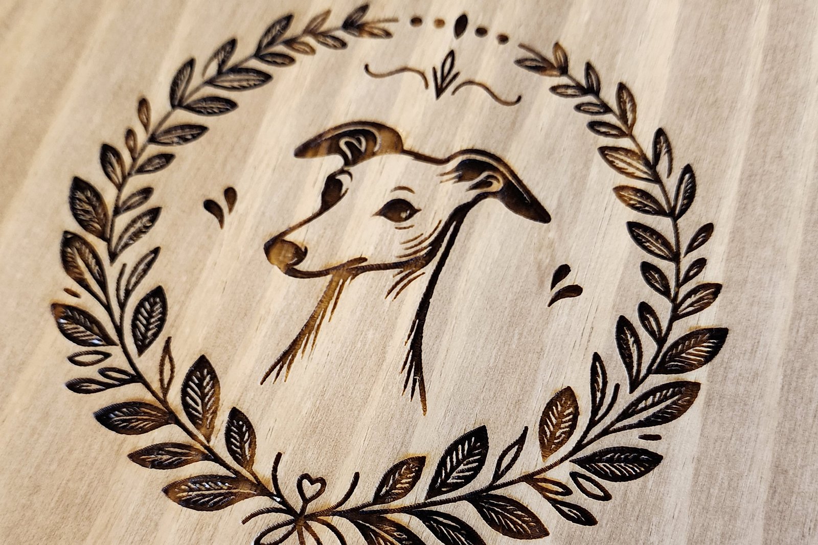 Laser engraved dog head on wood